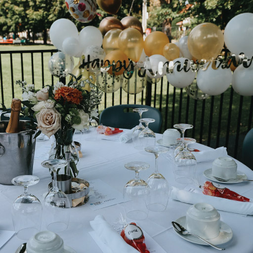 Niagara College Aurora Armoury's outside patio with table for birthday celebration with fine dining serving and balloons