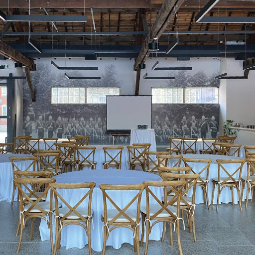 Mess Hall for Corporate Business Meetings with restaurant chairs, tables and projector at Niagara College Aurora Armoury