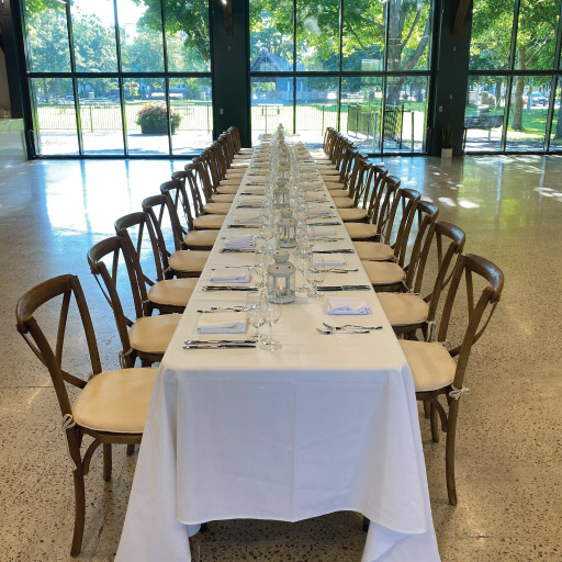 Niagara College Aurora Armoury's big hall with long table for a big gathering with fine dining serving